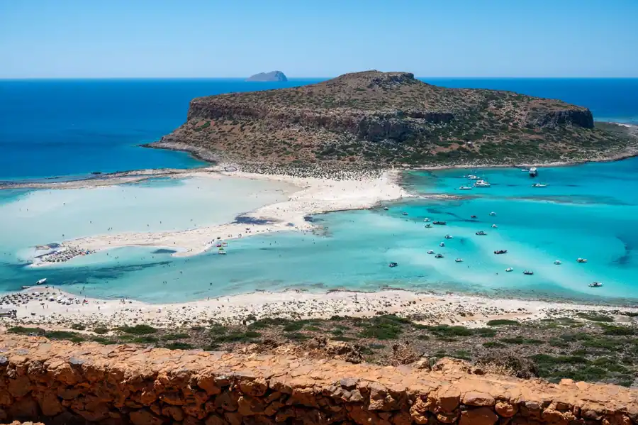 A breathtaking aerial view of Balos Lagoon in Chania, Crete, showcasing clear turquoise waters and sandy shores