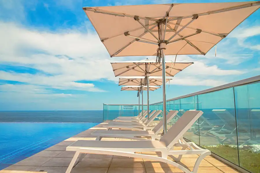 Relax by the infinity pool with ocean views at a luxurious El Salvador resort.